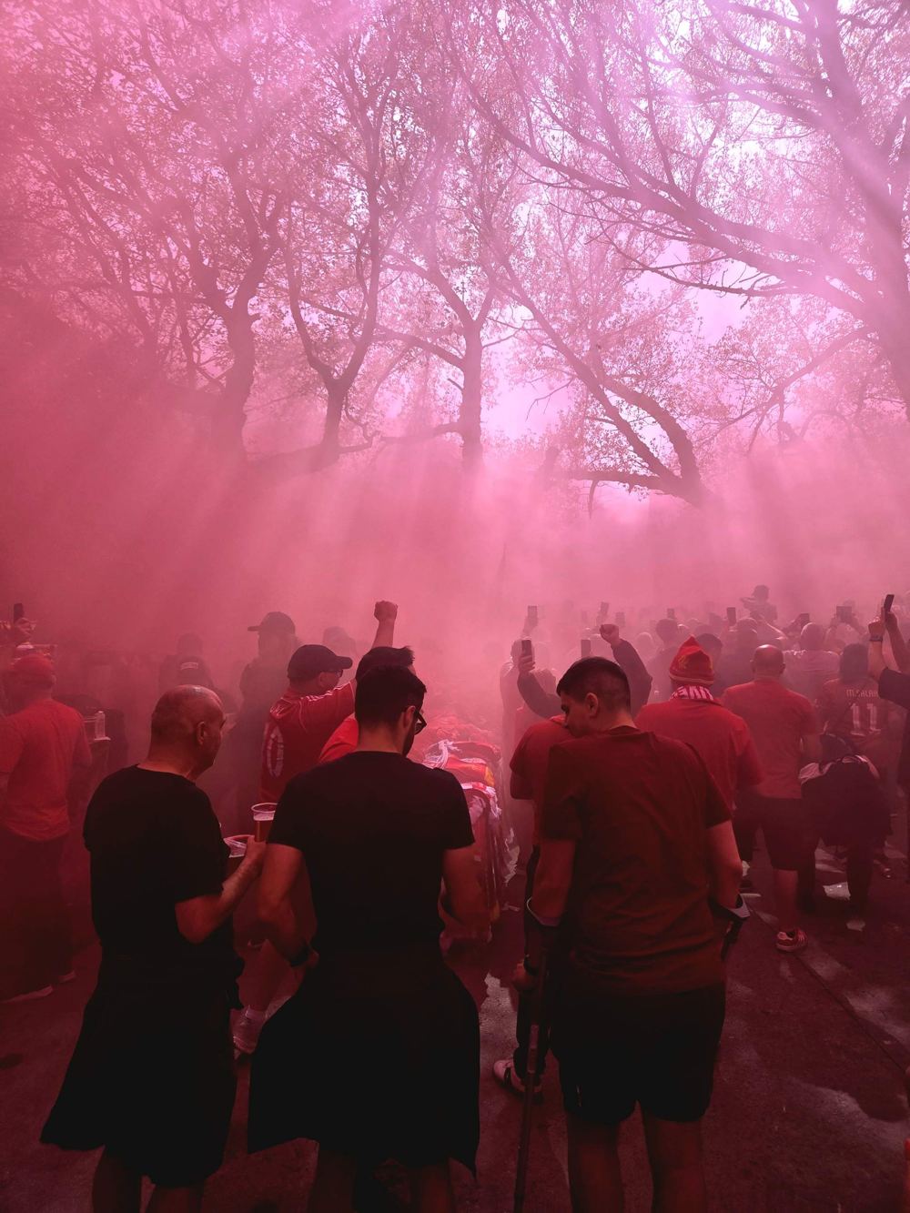 Liverpool fans in a cloud of red smoke on matchday